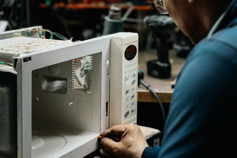 Técnico consertando micro-ondas